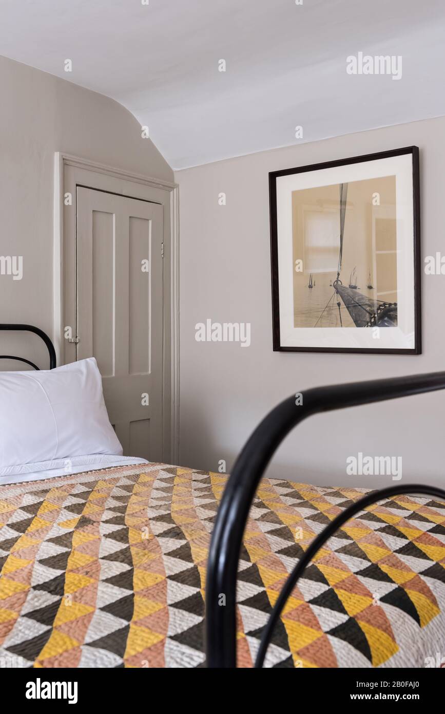 The quilted counterpane is one of a large number from a Chelsea artist