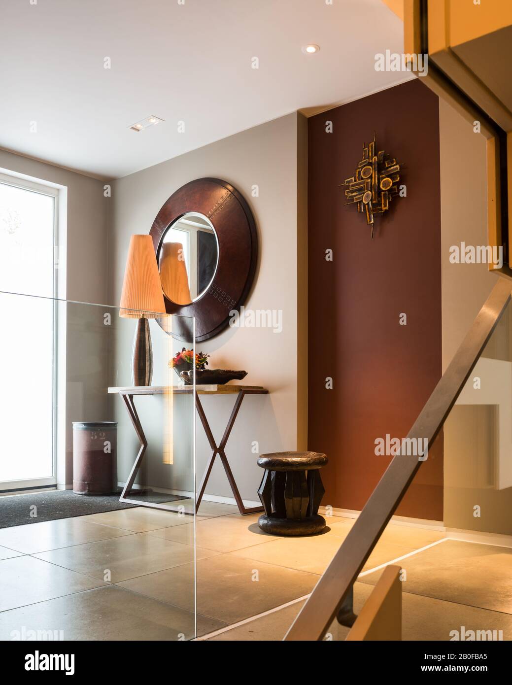 Large mirror above table in hallway of modern Wset London apartment Stock Photo Alamy