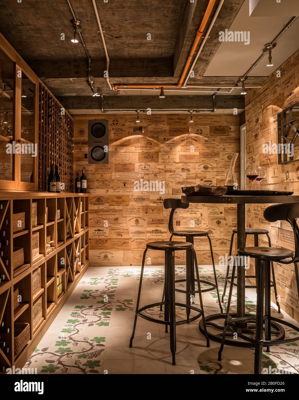 Wall cladding in wine cellar made from old wine boxes and grapevine floor tiles from Emery & Cie Stock Photo