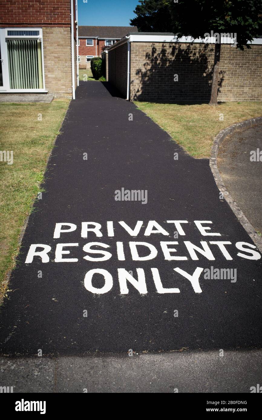 A pathway entrance to a residential flats marked with private residents only. Stock Photo