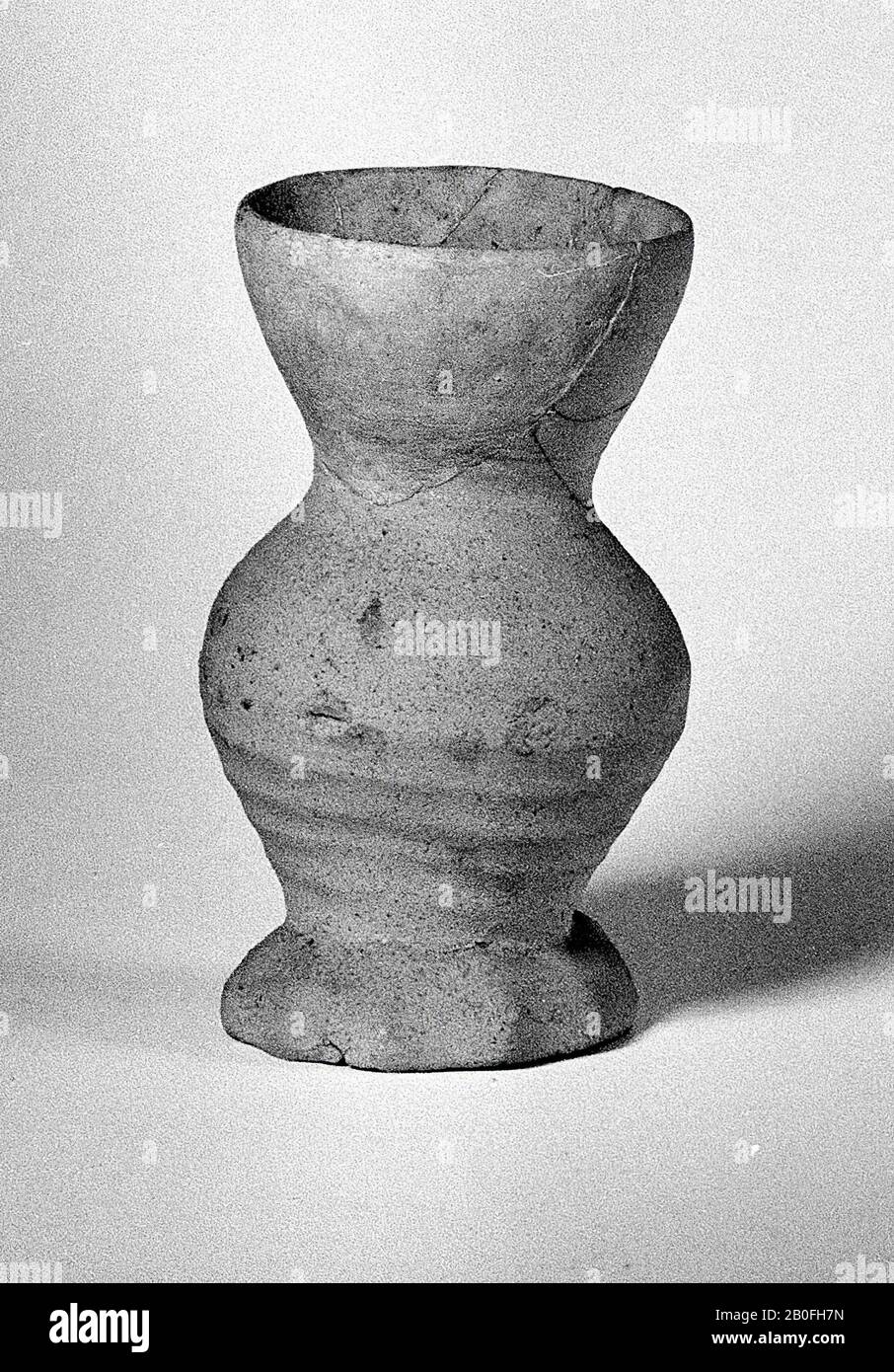 Cup of light gray earthenware, 15th century. Old glues and additions., Cup, earthenware (smooth wall), h: 11.4 cm, diam: 7 cm, lmeb 1375-1425 AD, Netherlands, Gelderland, Buren, Zoelen Stock Photo