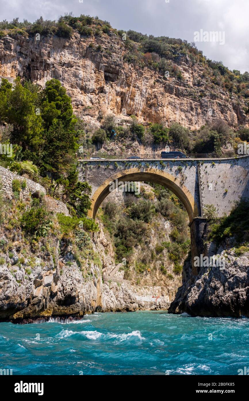 View from the water of Fiordo di Furore arched stone bright on the Amalfi Coast of Italy Stock Photo