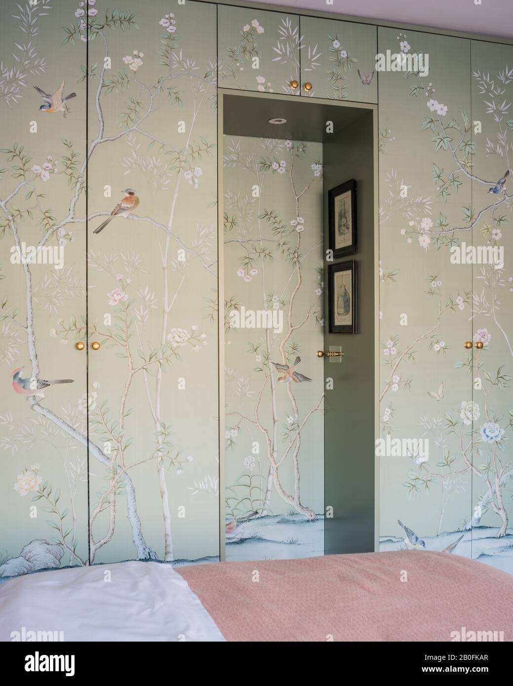 Chinoiserie wall paper covering wardrobe doors. Stock Photo
