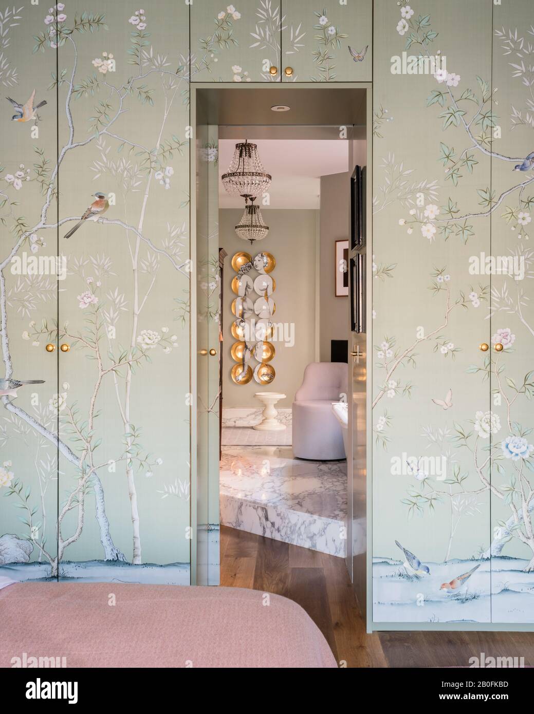 Chinoiserie wall paper covering wardrobe doors. Stock Photo