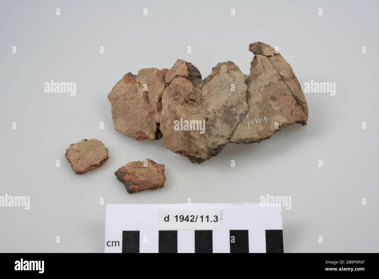 Fragment of the bottom of a pot of earthenware with 2 separate fragments. Old glueing., Pot, fragments, pottery, 12.5 x 8.5 x 6.2 cm, prehistory, The Netherlands, Gelderland, Winterswijk, Ratum Stock Photo