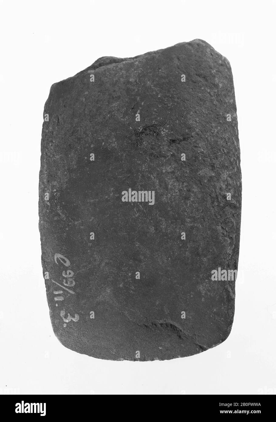 four-sided chisel of gray limestone, one side broken, ax, stone, length: 7.6 cm, prehistoric -4000 Stock Photo