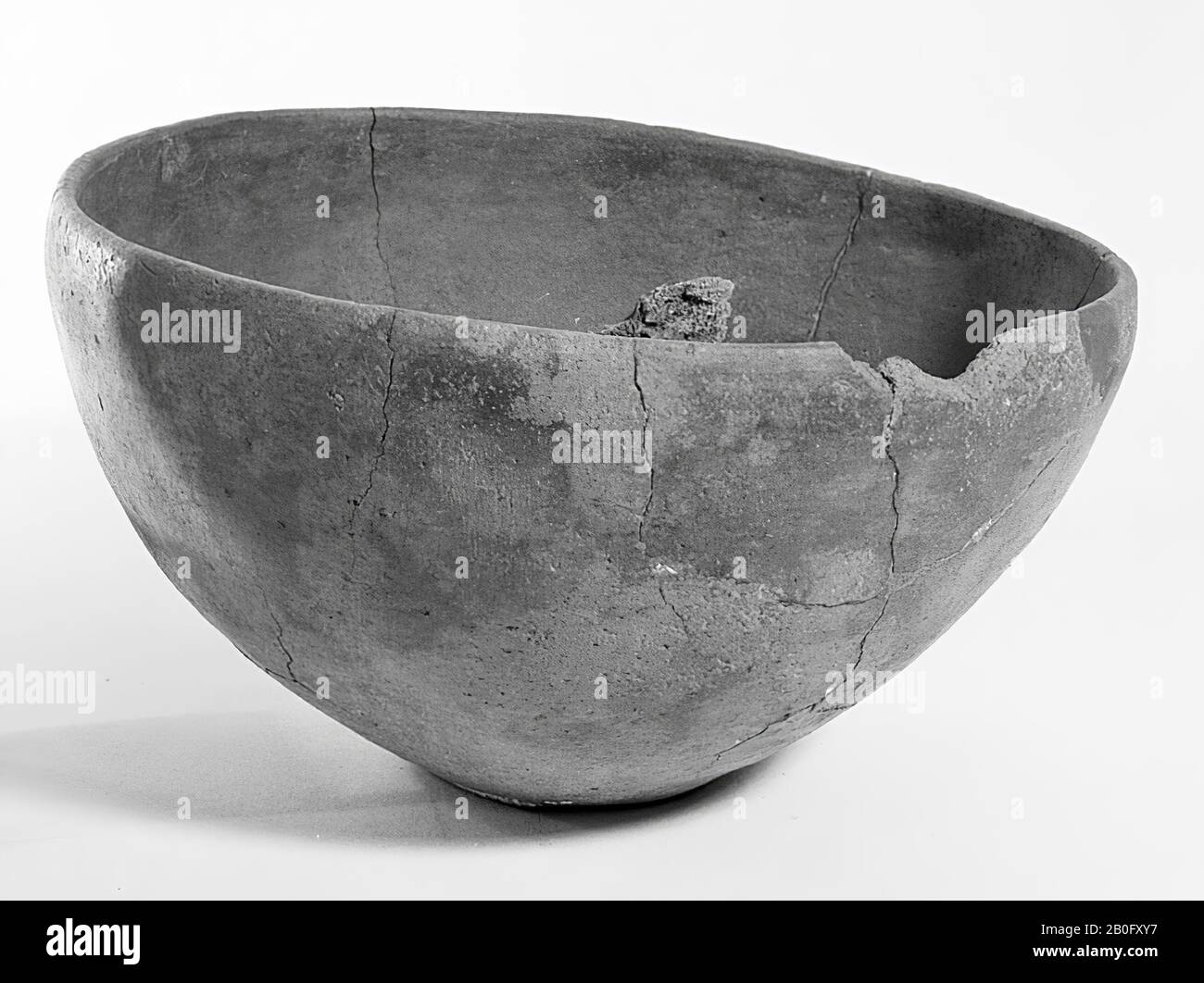 Dish-shaped urn of earthenware. Old bondings and additions, cracks. Contains cremated residues, urn, earthenware, h: 11.5 cm, diam: 21 cm, prehistory -1200 Stock Photo