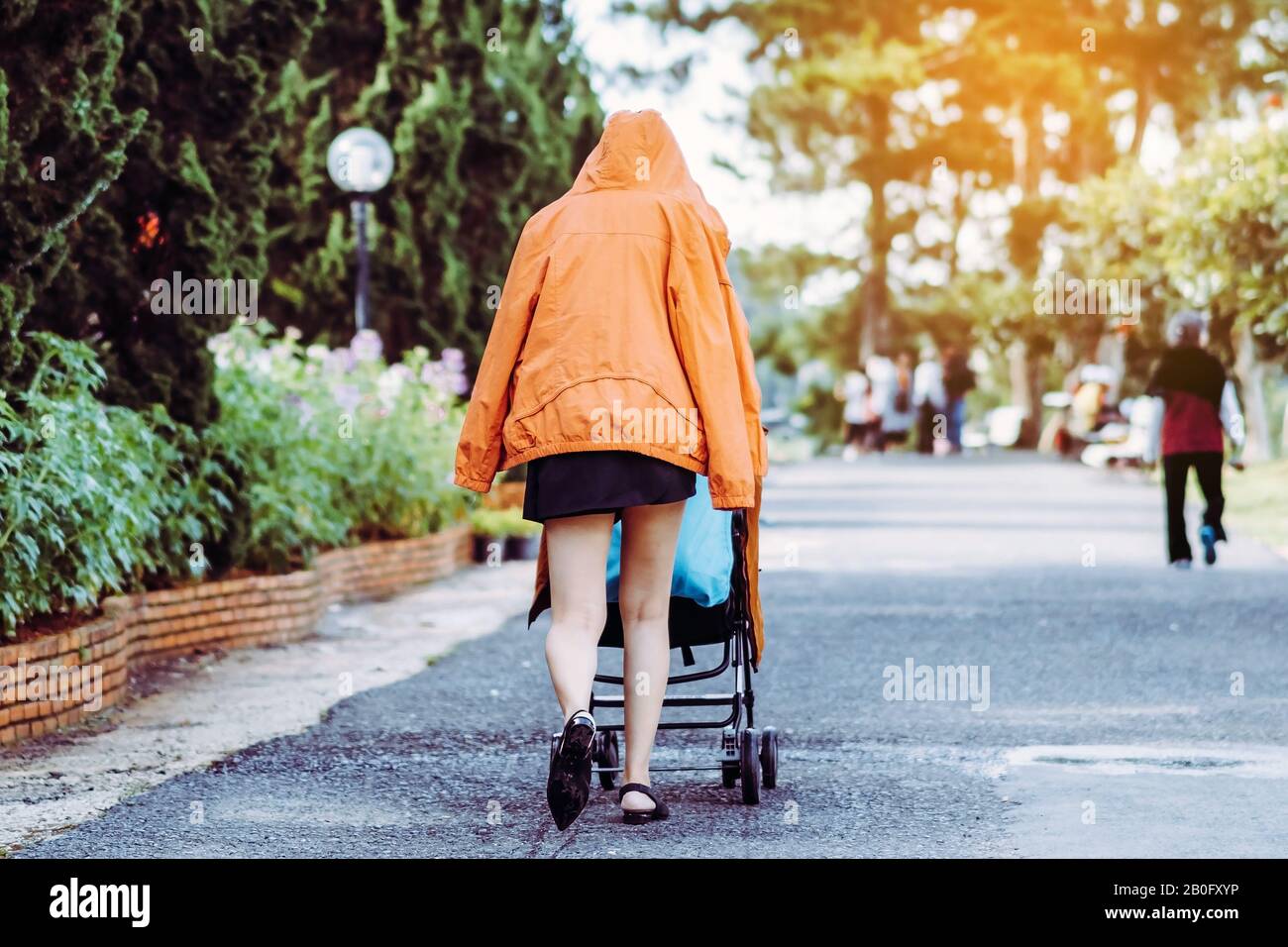 short skirt with baby stroller walks 