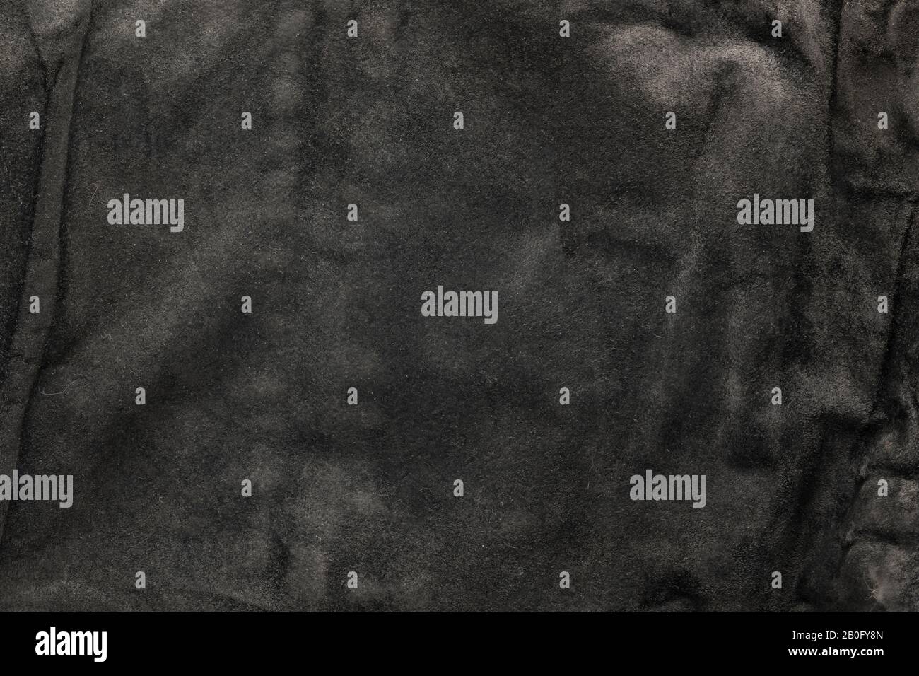 black structural background - old shabby stylish suede, reverse side, old fabric, textile. Stock Photo