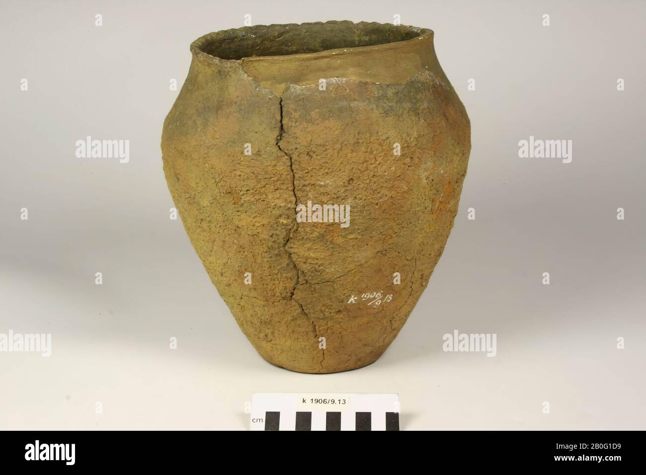 Urn of red-brown baked earth, rather coarse. Finger prints on the edge. Unstable old bonding and additions, different cracks: splitting and filling in the edge to the bottom., Small potty 1906 Stock Photo