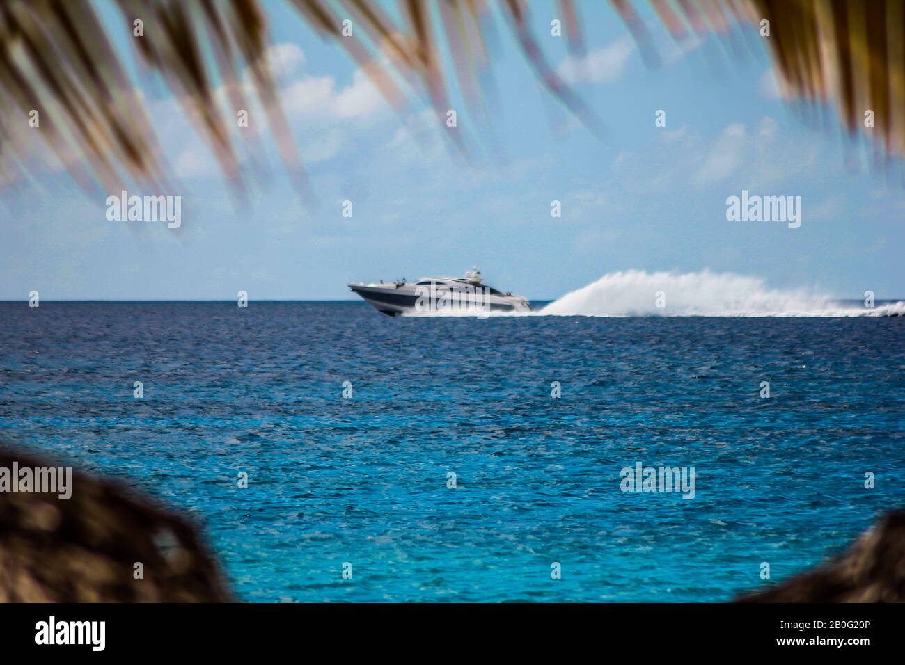 Motorboat speeds over the sea in the Dominicus coast 3 Stock Photo - Alamy