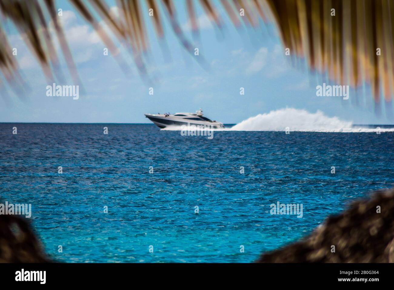 Motorboat speeds over the sea in the Dominicus coast 2 Stock Photo - Alamy