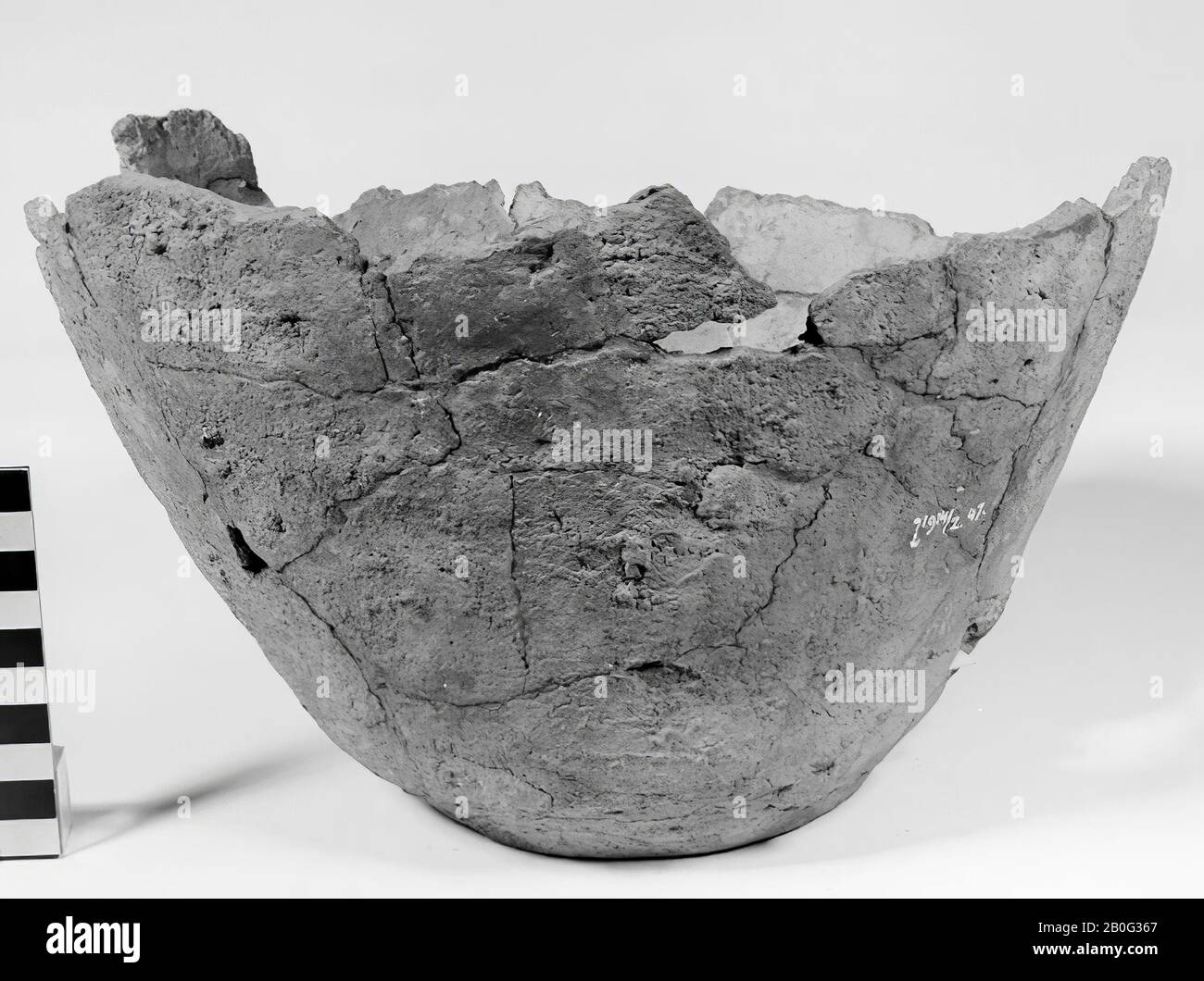 Fragment of a Germanic urn of earthenware. Old bonding, 1 loose shard. Contains cremated residues., A part of the shards of this urn is in a bag with shards of l 1914 Stock Photo
