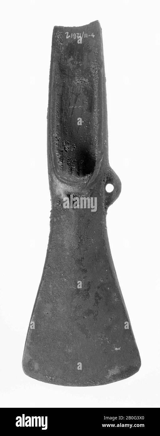 bronze heel ax with small ear and small triangular dimple below the heel. At the base of the heel one groove on one side and one on the other side (casting error). In the incrustation still vague wood chips of the stem, ax, metal, bronze, 18.1 x 6 cm, prehistory -1600 Stock Photo