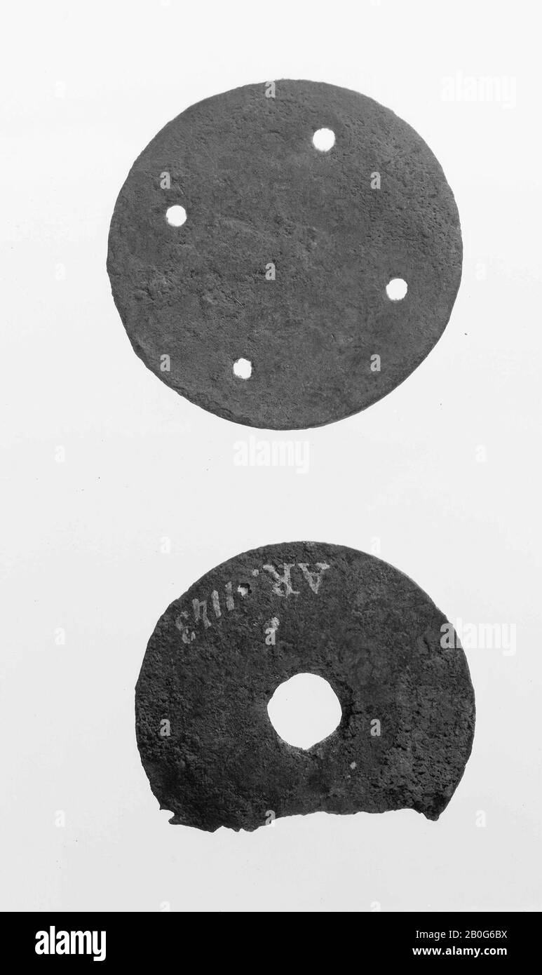 Bronze plate with a hole in the middle. Partly demolished., Hardware, metal, bronze, roman 50-270, Netherlands, South Holland, Leidschendam-Voorburg, Voorburg, Arentsburg Stock Photo