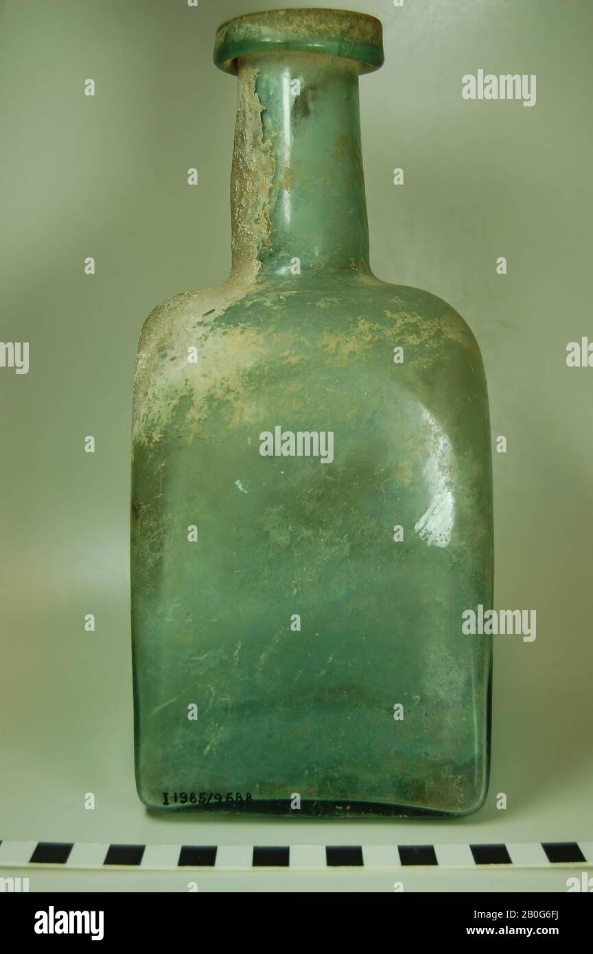 Large square bottle with round neck. The soil is completely flat. Convex shoulder, straight upward slightly tapered neck, turned big lip. No ear. Light green., Bottle, glass, ca. 23,5 cm, Roman time, Turkey Stock Photo
