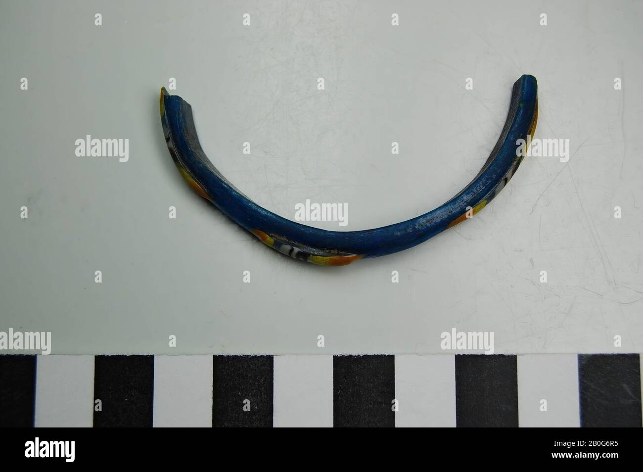 Fragment of glass bracelet with decoration in blue, yellow and orange. Old inventory number: 12287., bracelet, fragment, glass, 6 cm, Roman 50-100, Egypt Stock Photo