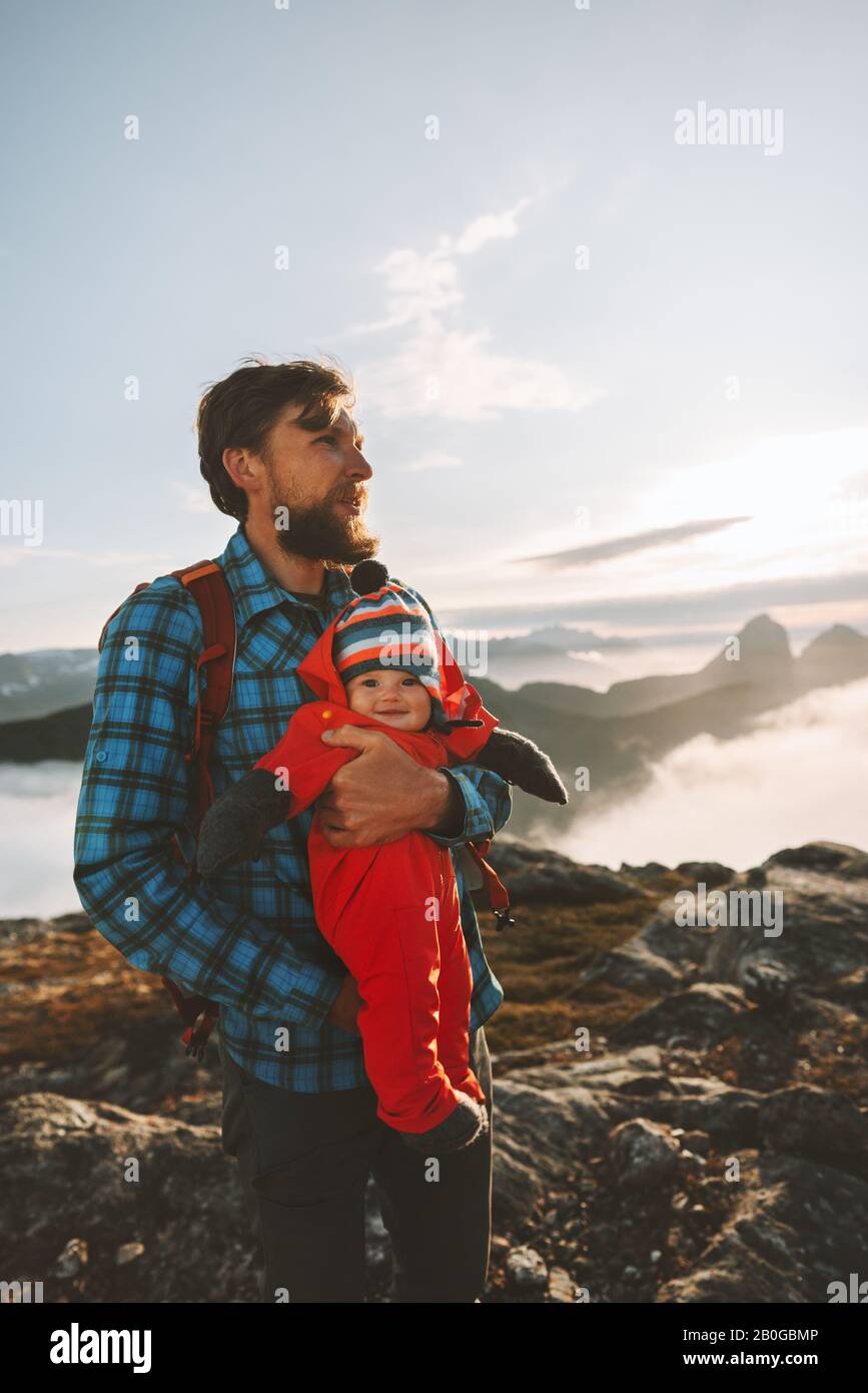Family vacations father with baby traveling in mountains man with child hiking outdoor eco tourism vacations together active healthy lifestyle Stock Photo