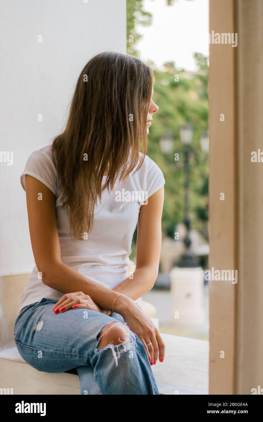 Crossed legs wearing blue jeans hi-res stock photography and images - Alamy