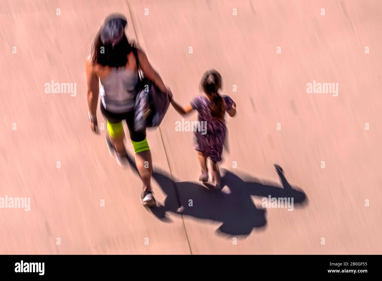 Mother and Daughter walking hand in hand. Blured Motion. RZXT1546.tif Stock Photo