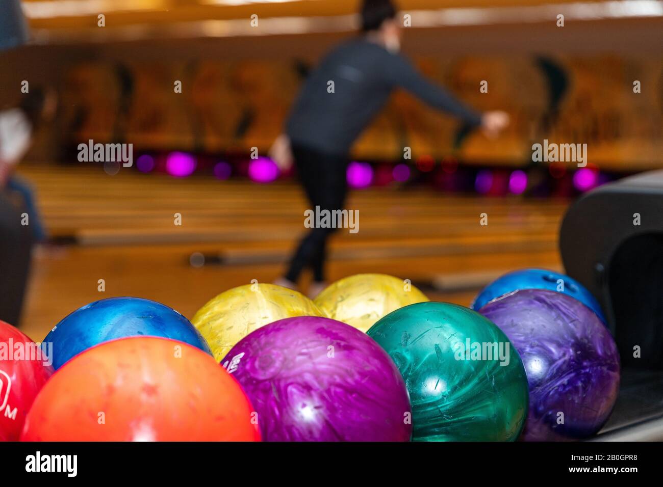Colorful and vibrant bowling balls, with lanes in the background, with copy space Stock Photo