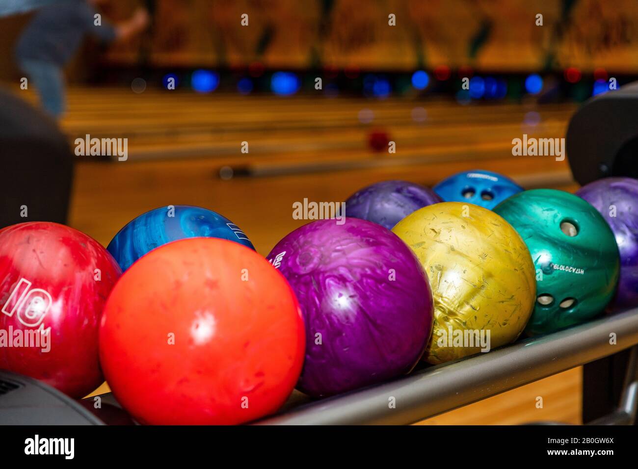 Colorful and vibrant bowling balls, with lanes in the background, with