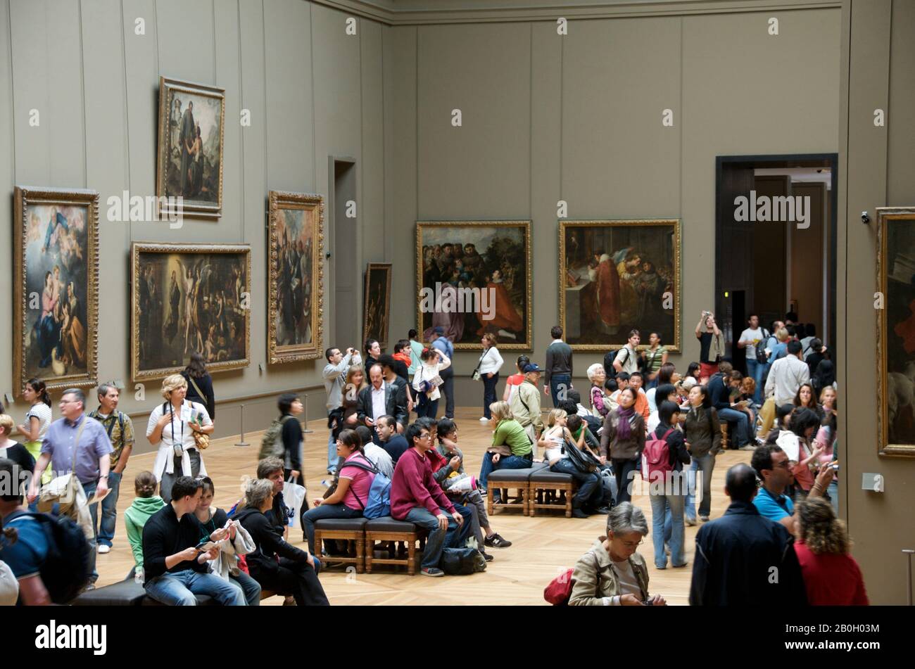 The Louvre, interior with people viewing the paintings, Paris, Ile de France, France Stock Photo