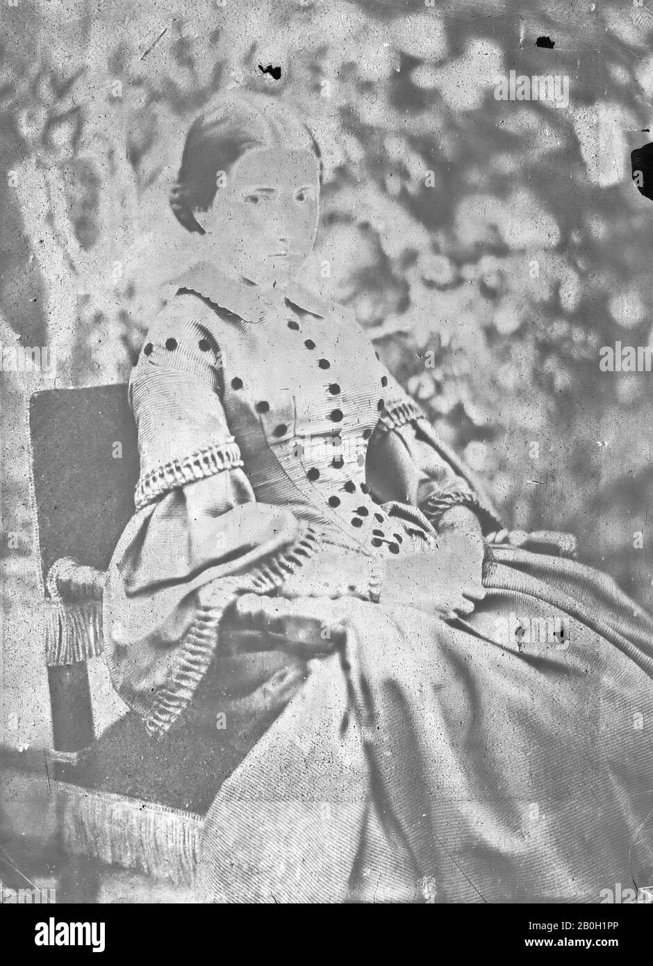 Jean Baptiste Frénet, French, 1814-1889, Young Woman Seated in a Garden, c. 1855, Waxed salted paper print from collodion-on-paper negative, Overall: 8 9/16 x 6 5/16 in. (21.8 x 16 cm Stock Photo