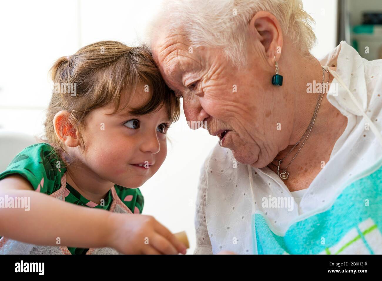 grandmother and granddaughter resting their heads with love Stock Photo