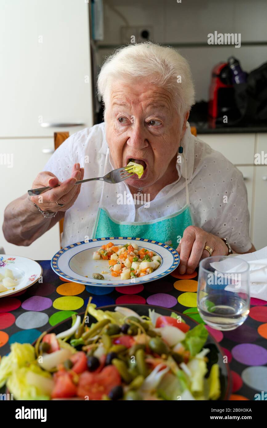 Old lady eating alone healthy food at home Stock Photo