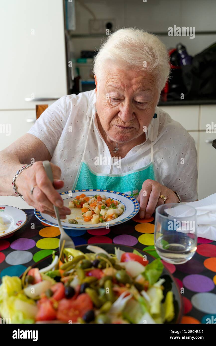 Old lady eating alone healthy food at home Stock Photo