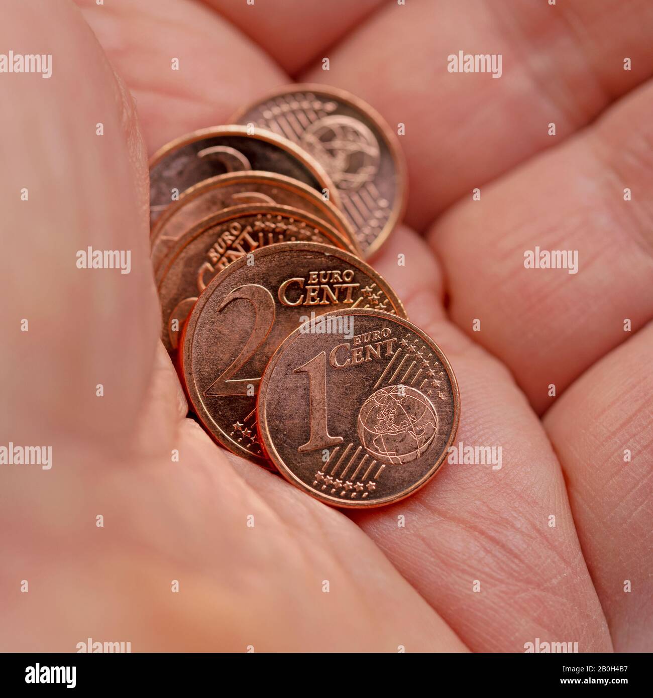 Small euro cent coins in hand Stock Photo