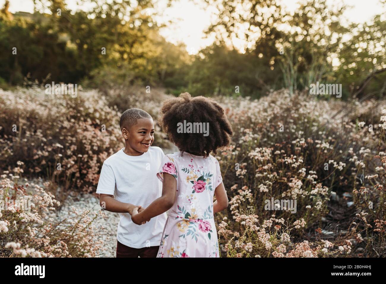 Two children holding hands school hi-res stock photography and images ...