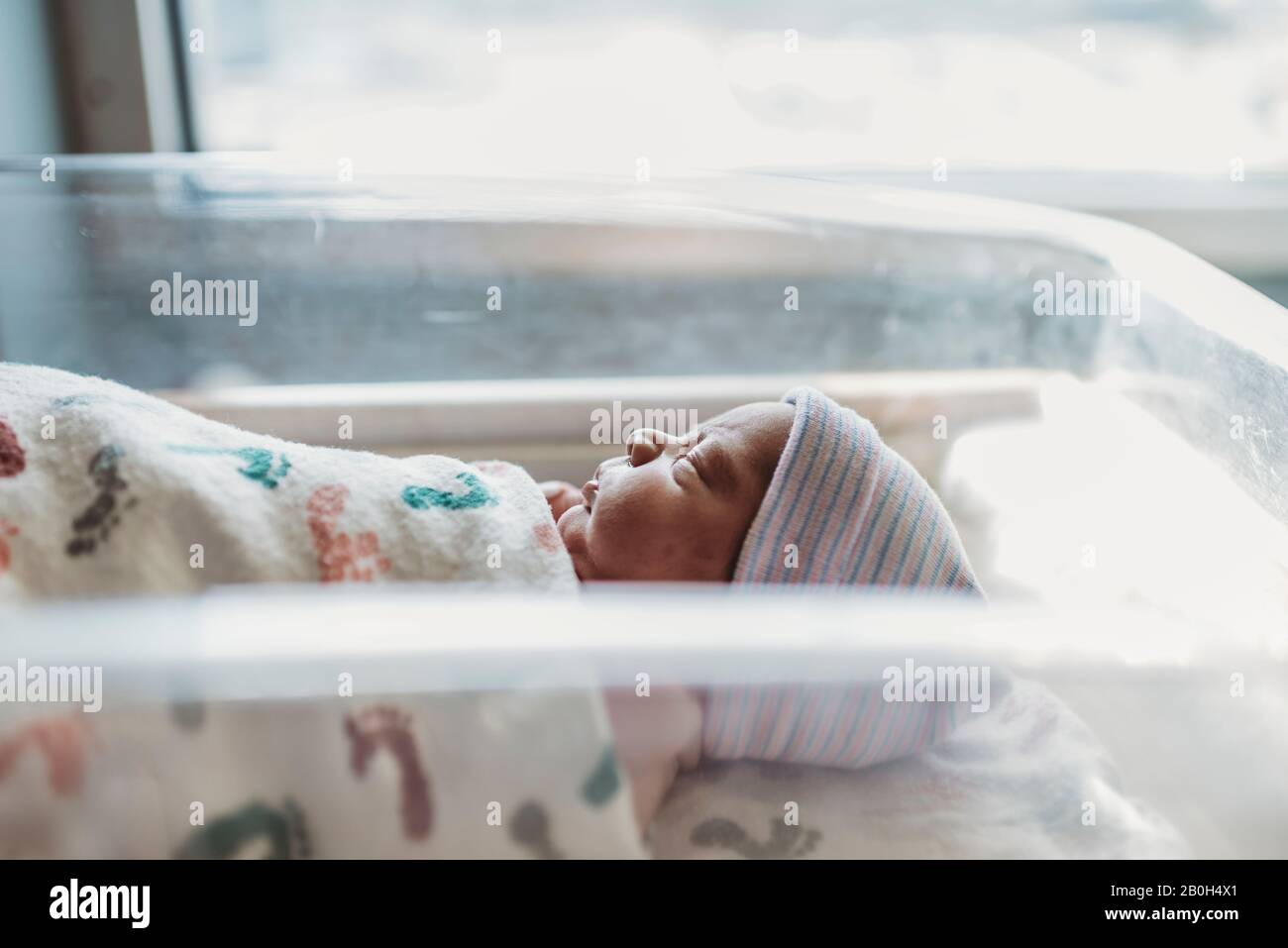 Side view of newborn boy profile with hat in hospital Stock Photo