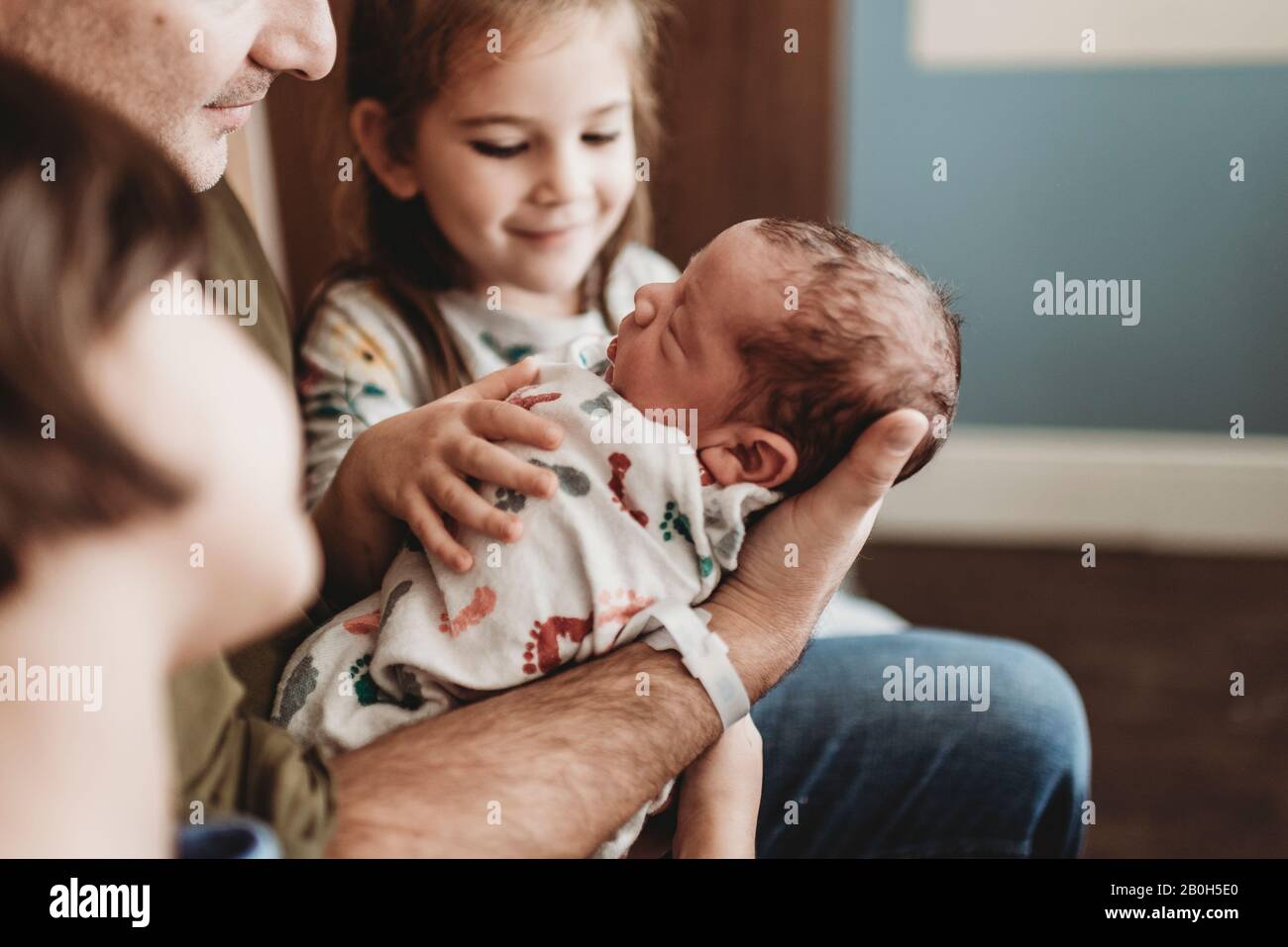 Close up side view of newborn boy and family in hospital with family Stock Photo