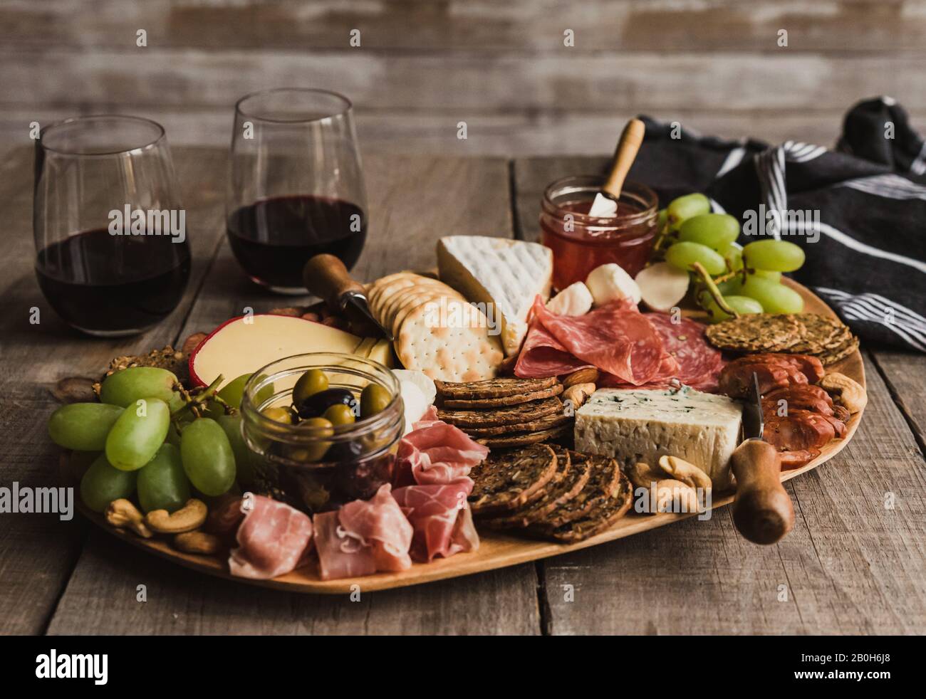 Close up of charcuterie board and glasses of wine on wooden table Stock  Photo - Alamy