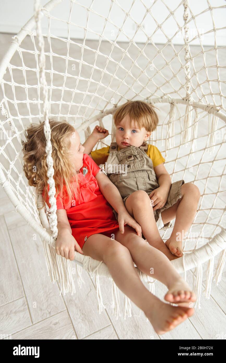 children swinging on a swing Stock Photo