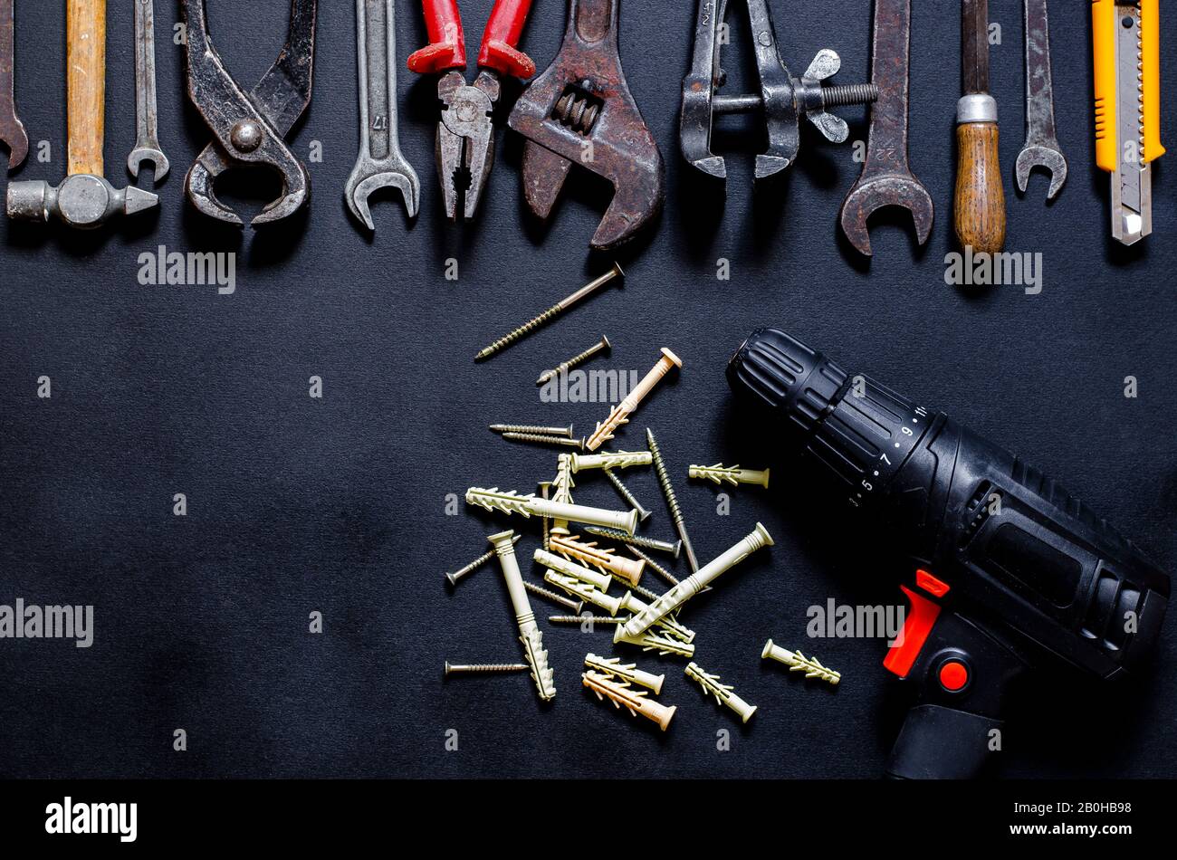 Construction worker tools on a dark background top view. Stock Photo
