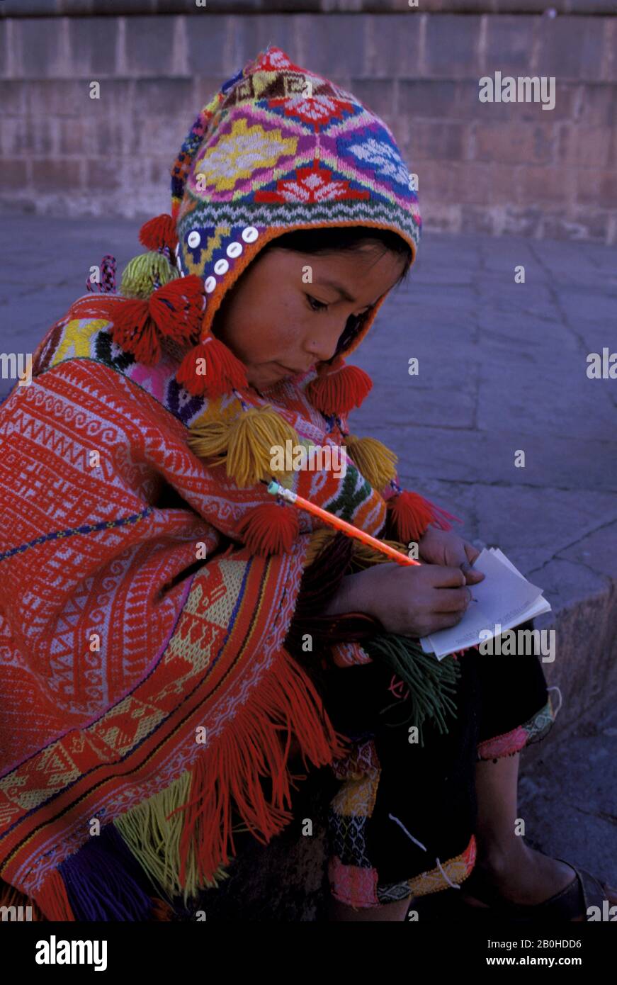 PERU, CUZCO, LOCAL BOY IN TRADITIONAL CLOTHING (QUECHUA), WRITING Stock Photo Alamy