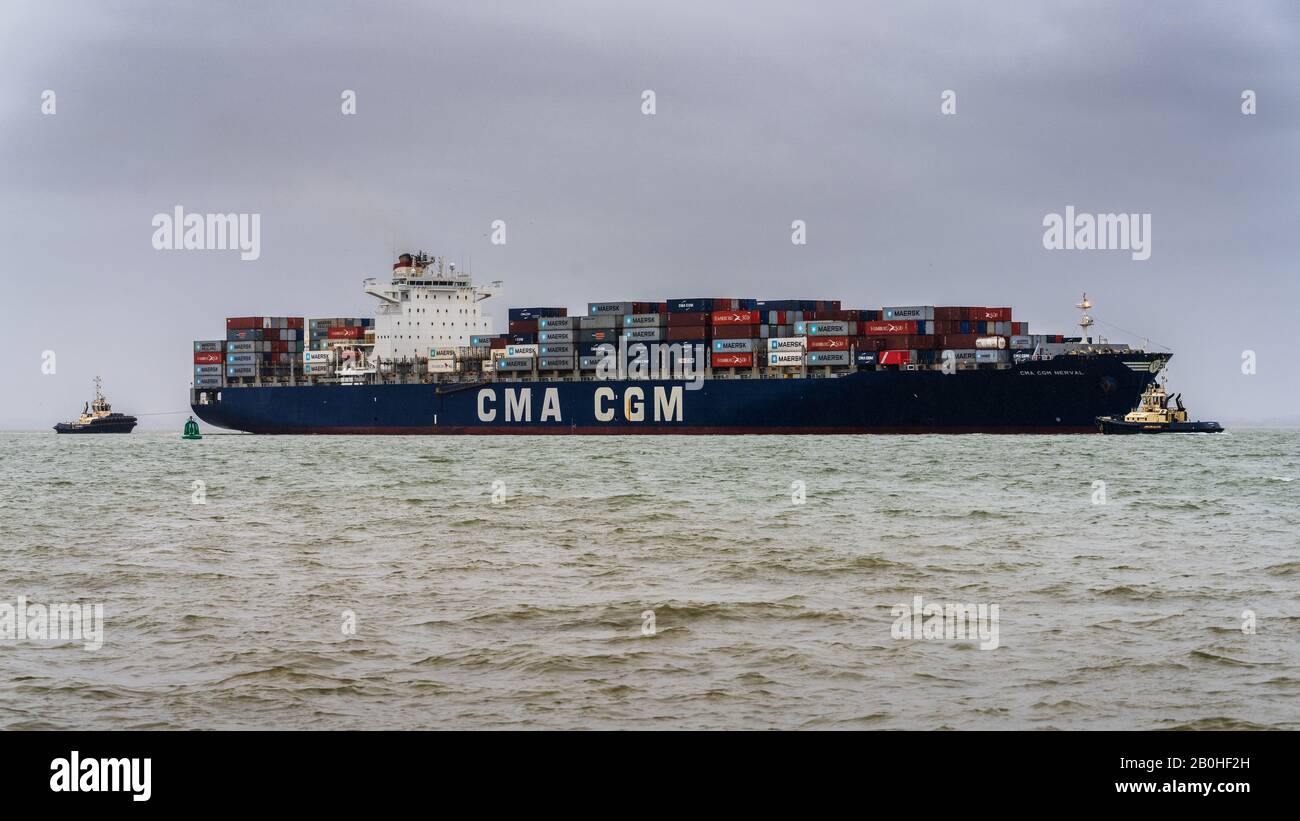 CMA CGM Nerval container ship manoeuvres to enter Felixstowe Port to unload containers. CMA CGM is a French container transportation and shipping Co. Stock Photo