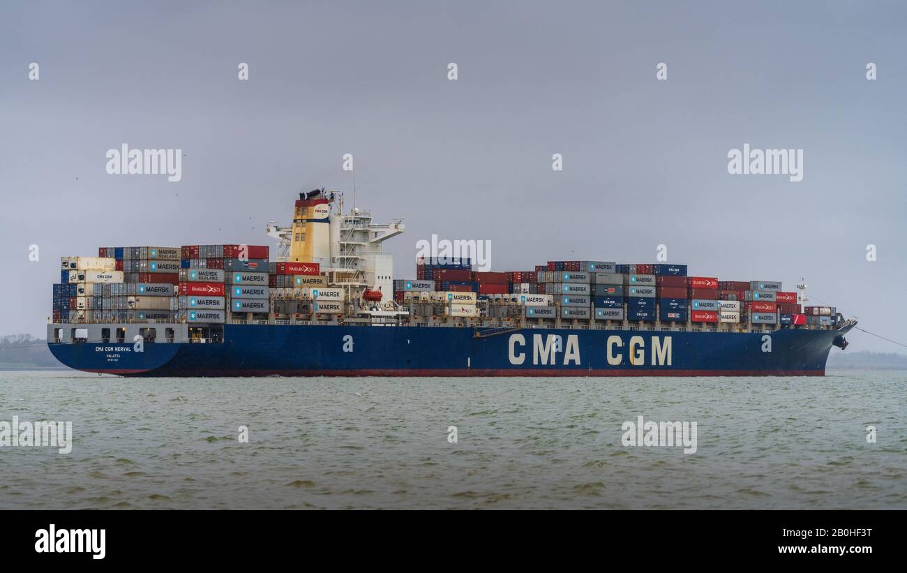 CMA CGM Nerval container ship manoeuvres to enter Felixstowe Port to unload containers. CMA CGM is a French container transportation and shipping Co. Stock Photo