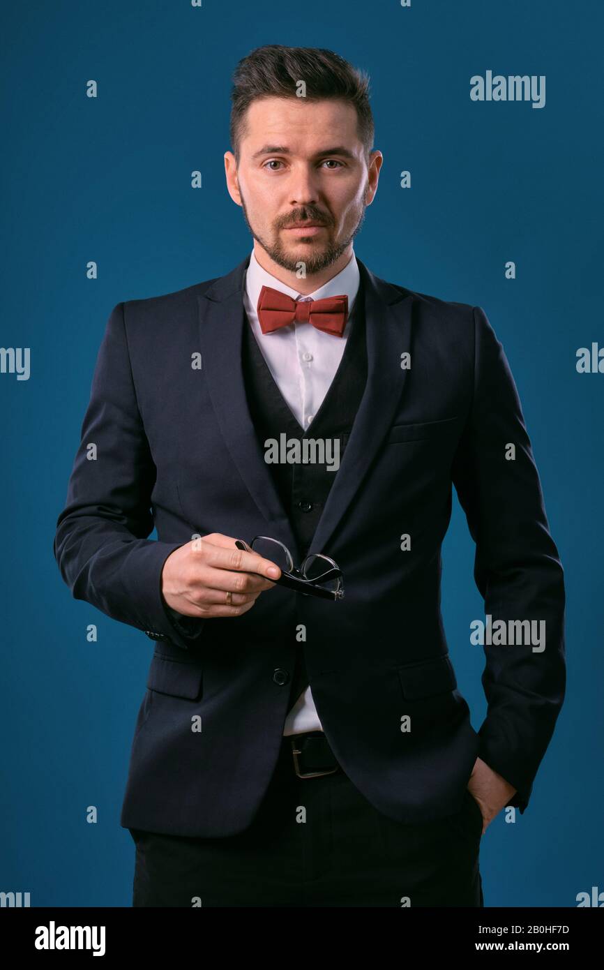 pics Black Suit Black Shirt Red Bow Tie https www alamy com young business man in classic black suit white shirt and red bow tie posing against a blue studio background mock up copy space close up image344592513 html