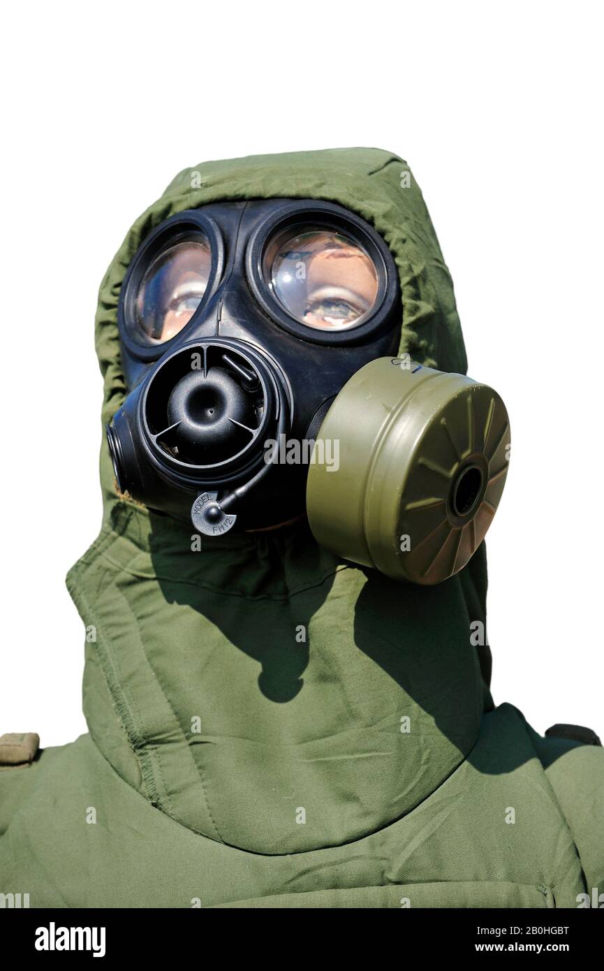 Soldier equipped with with gas mask / respirator and chemical warfare protection clothing against white background Stock Photo