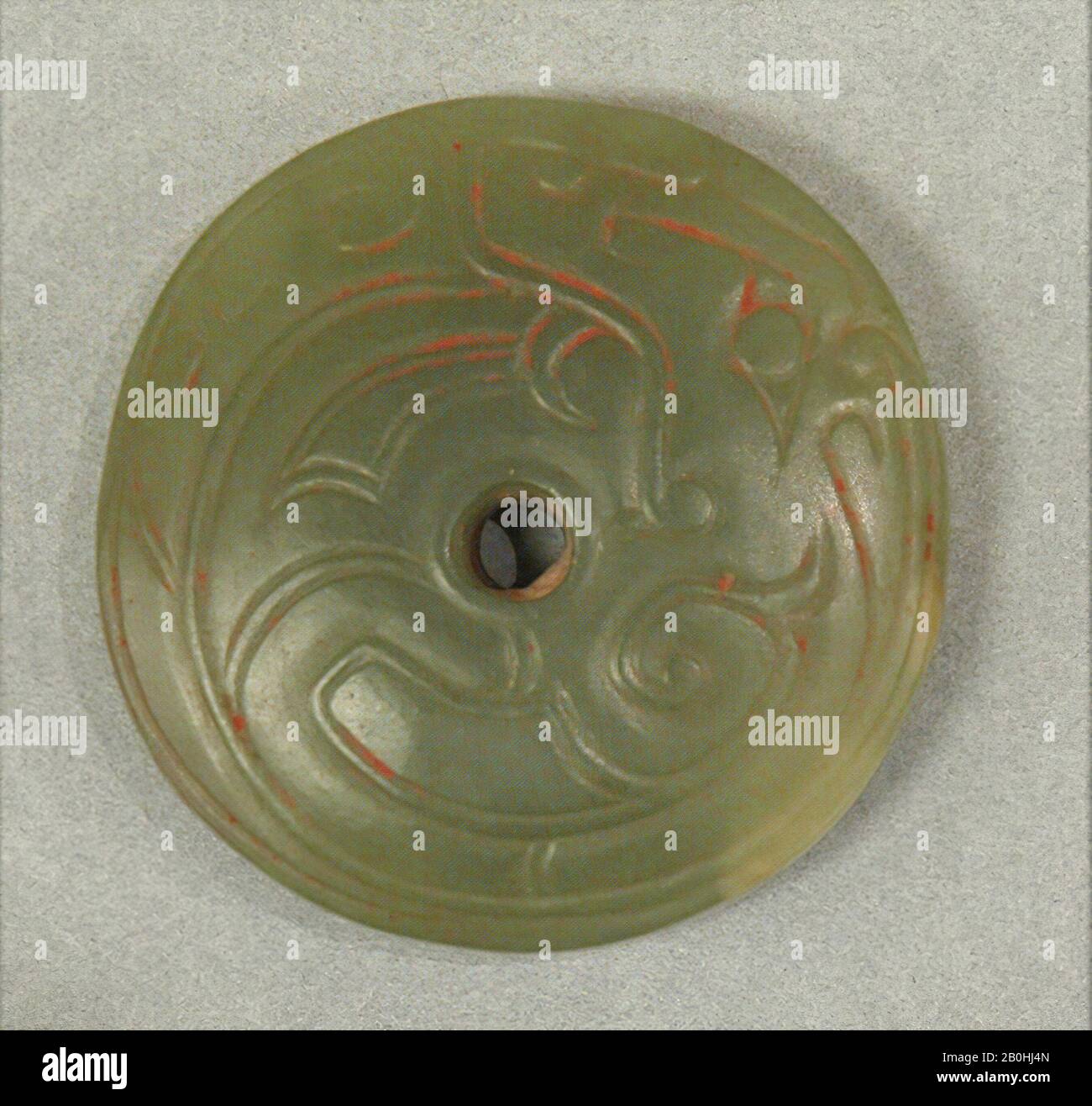 Pendant in the Shape of a Disk, China, Western Zhou dynasty (1046–771 B.C.), Date ca. 10th century B.C., China, Jade (Nephrite), Diam. 1 3/8 (3.5 cm); W. 3/8 in. (1 cm), Jade Stock Photo