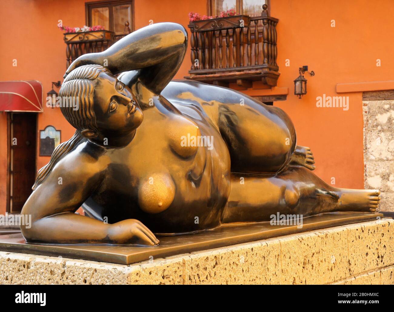 Artist Fernando Botero's bronze sculpture "La Gorda Gertrudis" reclining outside colonial building in Plaza San Francisco, Cartagena, Colombia Stock Photo