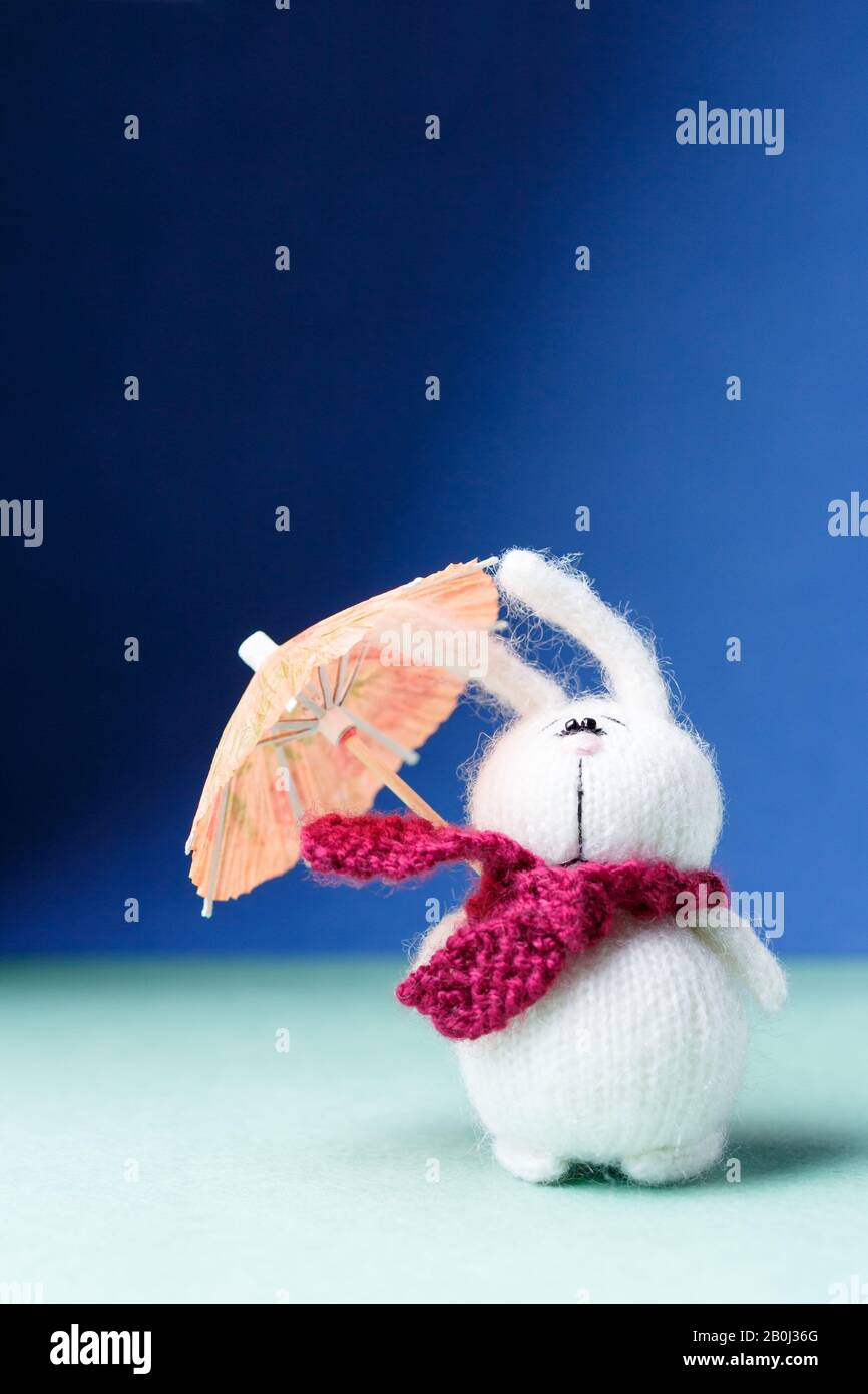 Melancholy concept. Rabbit character with umbrella. Windy rainy day ...