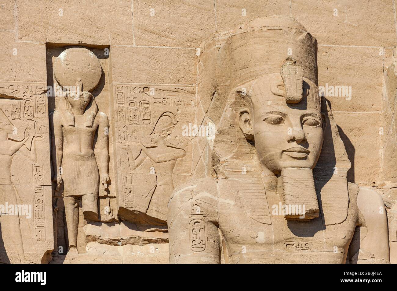 Statues of Ra-Horakhty and Ramses II at the entrance to the Great Temple of Abu Simbel Stock Photo
