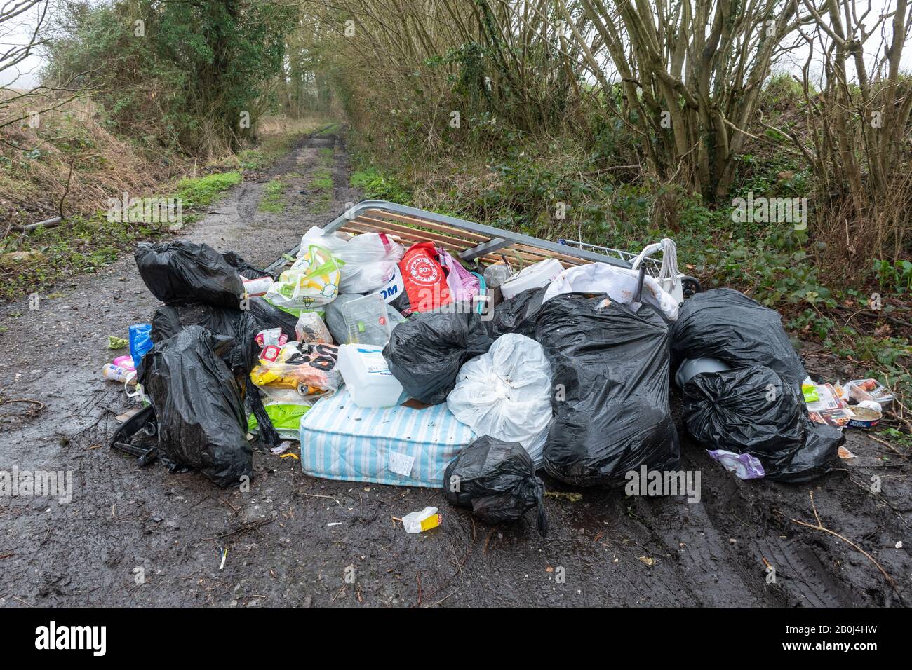 Large pile of fly tipped rubbish garbage litter waste refuse. Fly tipping problem in the UK countryside. Stock Photo