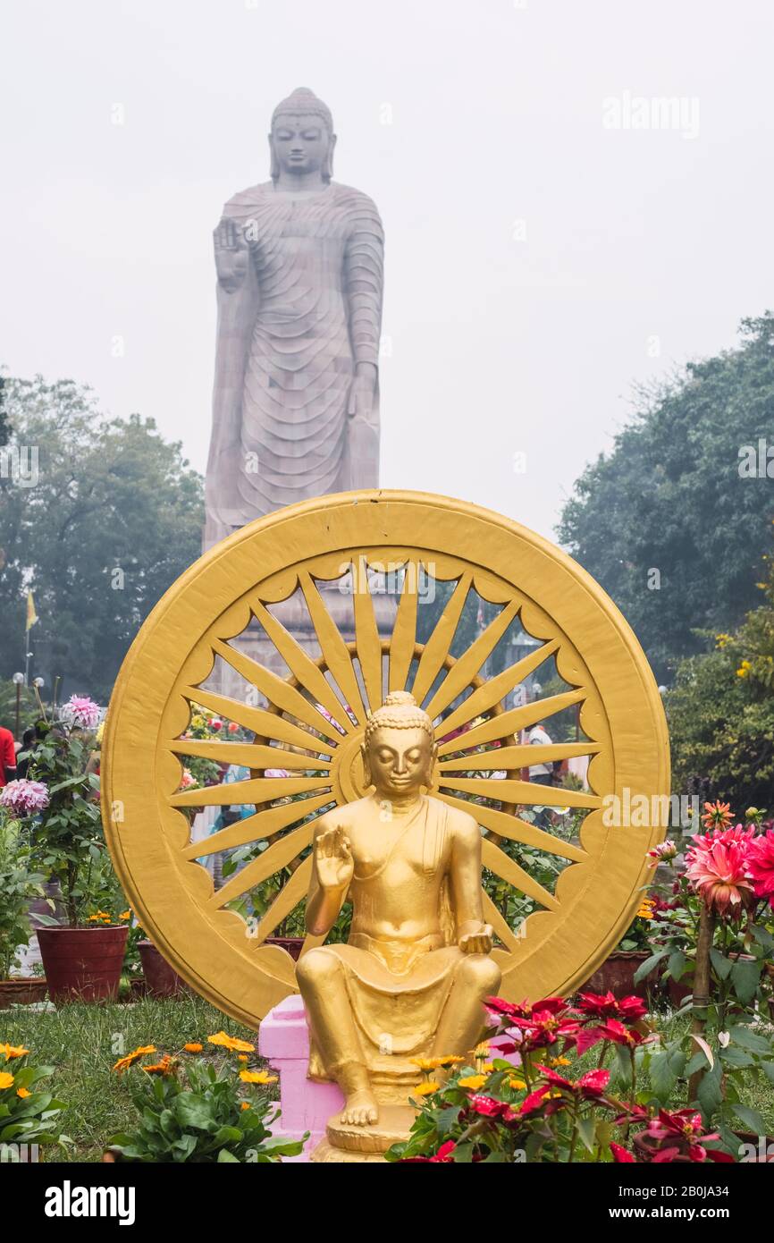 The Ashok Chakra with blurry background of Grand Statue of Buddha in WAT THAI Temple. Varanasi, India. Stock Photo