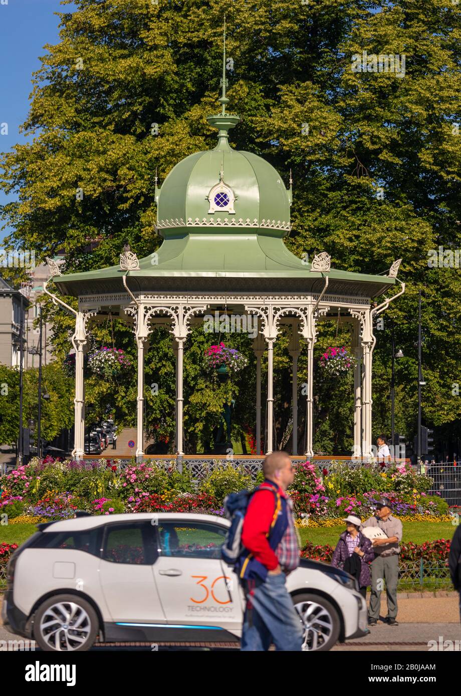 BERGEN, NORWAY - People and car pass in front of music pavilion in Byparken, a public park in downtown Bergen. Stock Photo